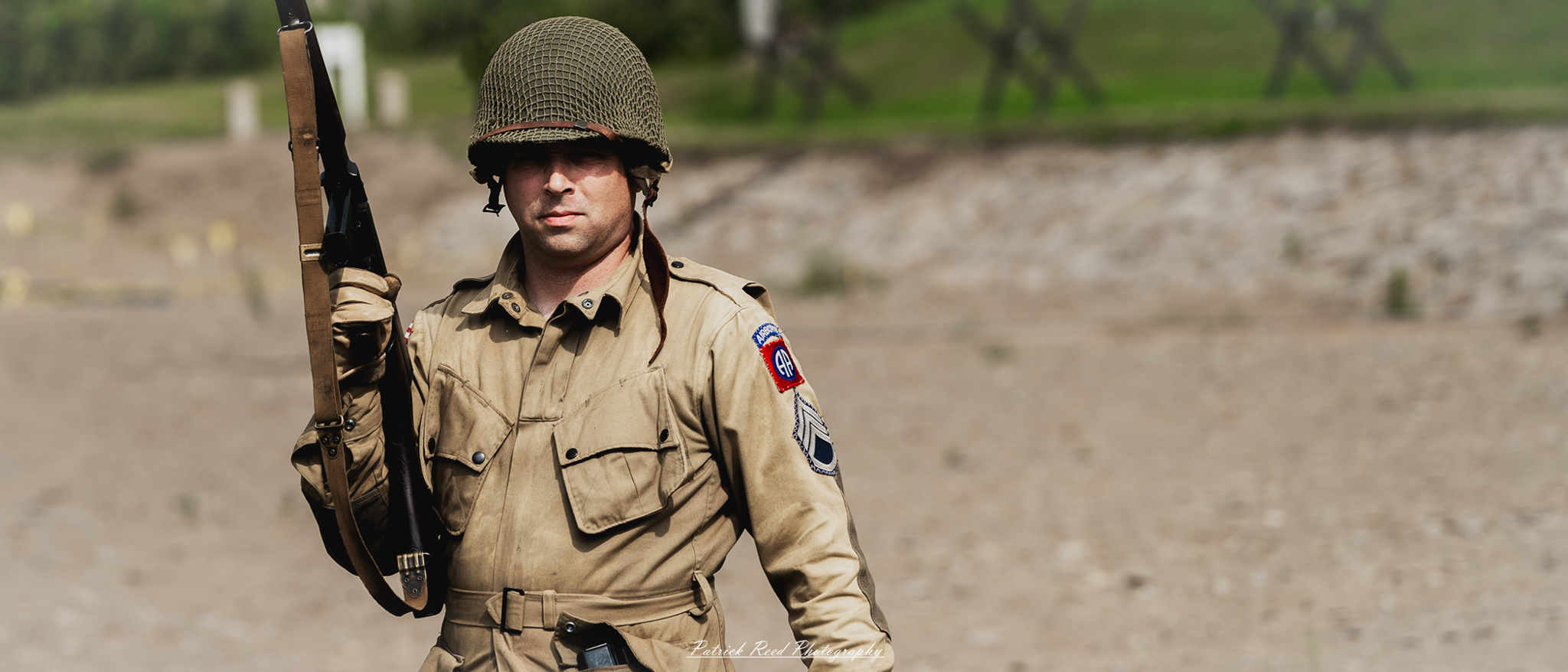 "A striking image of a soldier holding a Thompson submachine gun, often recognized by its distinctive design. The soldier grips the weapon with confidence, showcasing the iconic firearm's role in close-quarters combat."